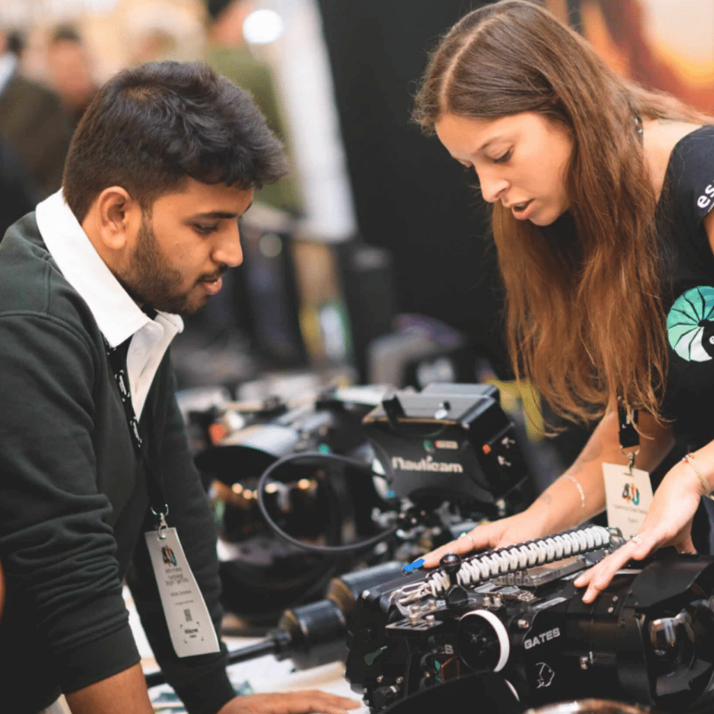 A kit distributor shows equipment to a delegate at Wildscreen Festival